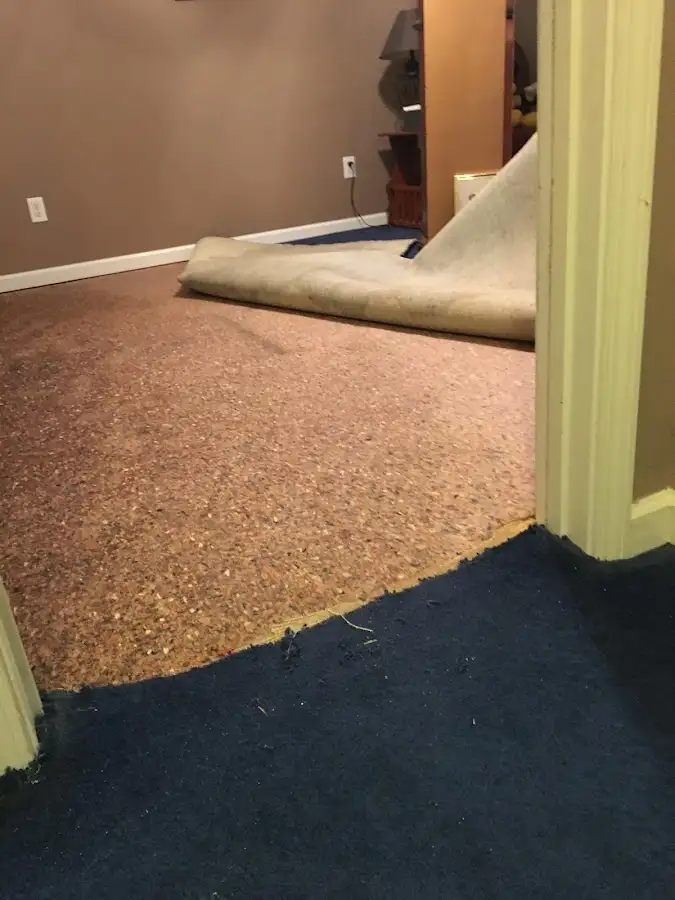 Carpet pad removal revealing water damage during Drying & Dehumidification in Hueytown